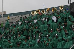 [North Texas Green Brigade Marching Band in the stands at football game]