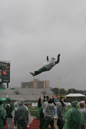 [Person flying mid-air at UNT football game]