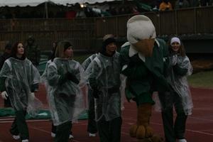 [Scrappy the Eagle standing with North Texas Dancers during a football game, 2]