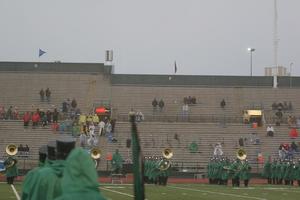 [Green Brigade Marching Band playing at a football game ]