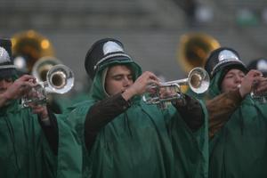 [Green Brigade trumpet players performing at football game]
