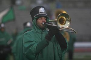 [Man playing trombone at a football game]
