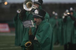 [Saxophone player performing at a football game]