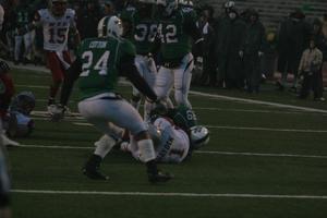 [UNT and WKU players on the field during a football game, 2]