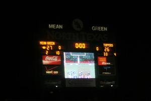 [Photograph of scoreboard at UNT football game]