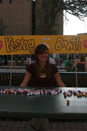 [UNT student sits in Kissing Booth at Mean Green Fling]