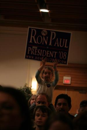 [Photograph of a child holding a Ron Paul sign]