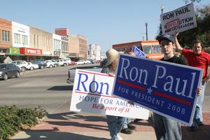 [Photograph of a group holding Ron Paul signs on the Square 2]