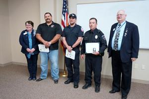 [Elizabeth Patel, John Anderson with first responders at awards ceremony]
