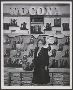 [Enid Justin standing in front of a Nocona Boot display]