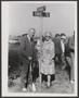 Photograph: [Enid Justin and a man standing next to an Enid street sign]