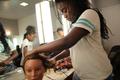 Photograph: [Student styles mannequin's hair at 2016 TBAAL Summer Youth Arts Inst…