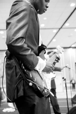 [Boy plays guitar during student performance, Ties and Tux 2014, 1]