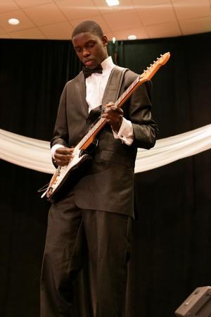 [Boy plays guitar during student performance, Ties and Tux 2014, 3]
