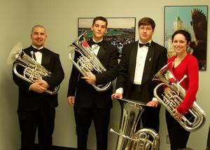[UNT tuba players pose with instruments]