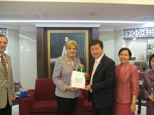 Primary view of object titled '[Man 2 receives gift from Gretchen Bataille at Thailand delegation meeting]'.