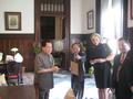 Primary view of [Charn Uswachoke, Gretchen Bataille, and Vish Prasad with man at Thailand delegation's meeting]