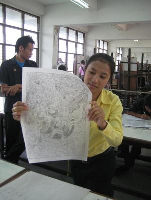 [Woman holds drawing of Suvannamaccha in Thailand classroom]