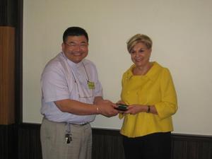 [Man 3 receives gift from Gretchen Bataille at NIDA delegation meeting]