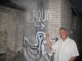 Photograph: [UNT faculty member poses with "liqun" graffiti]