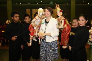 [Diane Crane poses with Thai puppets, 2]