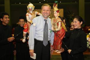 [Earl Gibbons poses with Thai puppets, 2]