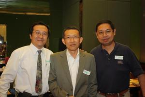 [Pijarn Charoensri and men at UNT alumni party in Bangkok]