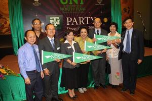 [Group photograph with UNT pennants at Bangkok alumni party, 1]