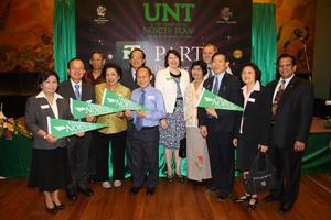 [Group photograph with UNT pennants at Bangkok alumni party, 2]