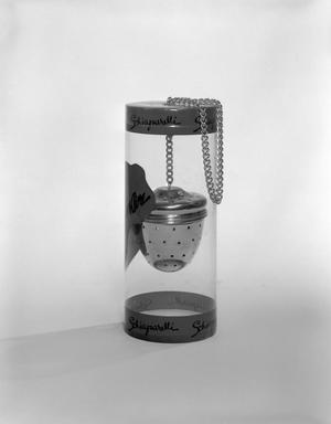 [Product photograph of a Schiaparelli branded infuser ball with chain]