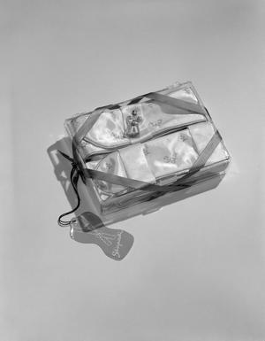 [Product photograph of a Schiaparelli gift box including a small perfume sample and folded fabric]