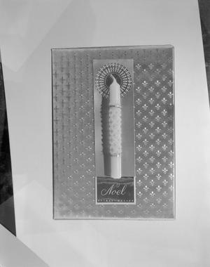 [Product photograph of gift wrapped in metallic paper and embellished with a candle and card]