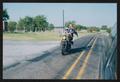 Primary view of [A motorcycle riding to the side of a driving van: Lone Star Ride 2002 event photo]
