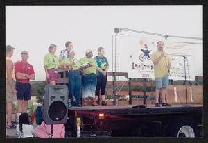 [Opening ceremonies stage speaker: Lone Star Ride 2002 event photo]