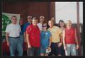 Primary view of [11 people posed by a KDL 106.7 radio station banner: Lone Star Ride 2003 event photo]
