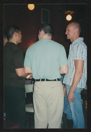 [Three men chatting with their backs to the camera: Lone Star Ride 2003 event photo]