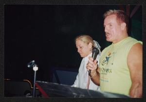 [Man speaking into a microphone: Lone Star Ride 2003 event photo]