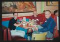 Primary view of [Three men eating at a restaurant booth table: Lone Star Ride 2003 event photo]