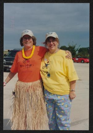 [Two volunteers, one in a grass skirt costume: Lone Star Ride 2003 event photo]