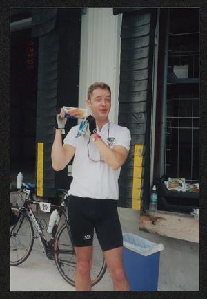 [Cyclist #26 holding a bread snack: Lone Star Ride 2003 event photo]