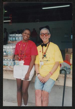 [Two crew members smiling leaned against a loading dock: Lone Star Ride 2003 event photo]