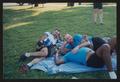 Photograph: [Three men laying on a blue blanket: Lone Star Ride 2003 event photo]