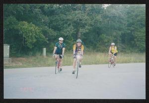 [Three cyclists pulling into the campgrounds: Lone Star Ride 2003 event photo]