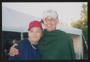 [Two older individuals in a side embrace: Lone Star Ride 2003 event photo]