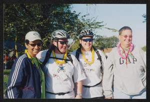 [Group of four in yellow and pink leis: Lone Star Ride 2003 event photo]