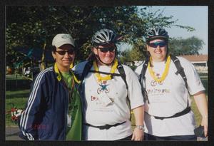 [Three individuals posing together in the late afternoon: Lone Star Ride 2003 event photo]
