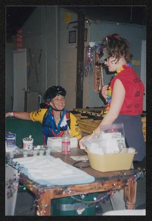 [Cyclist talking to a crew member in red at med pit #3: Lone Star Ride 2003 event photo]
