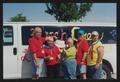 Primary view of [Janie Bush and others holding up a sponsorship paper in front of a white van: Lone Star Ride 2003 event photo]