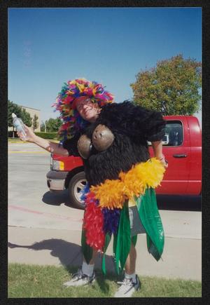 [Crew member in a coconut bra and other costume accessories: Lone Star Ride 2003 event photo