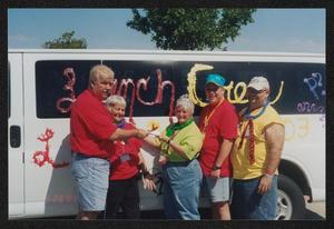 [Janie Bush and others exchanging paperwork in front of a white van: Lone Star Ride 2003 event photo]